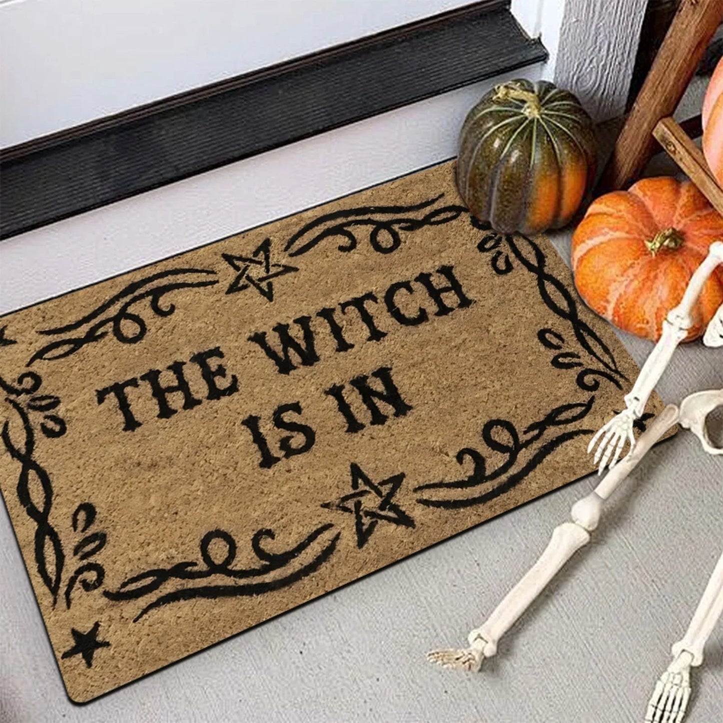 A Magical Doormat Featuring 'THE WITCH IS IN', Made of Plush Material with a Thickness of 0.4 Inches And Weighing 1.28 LB. It Has a Brown Base with a Black Star And Spell Design, for Halloween