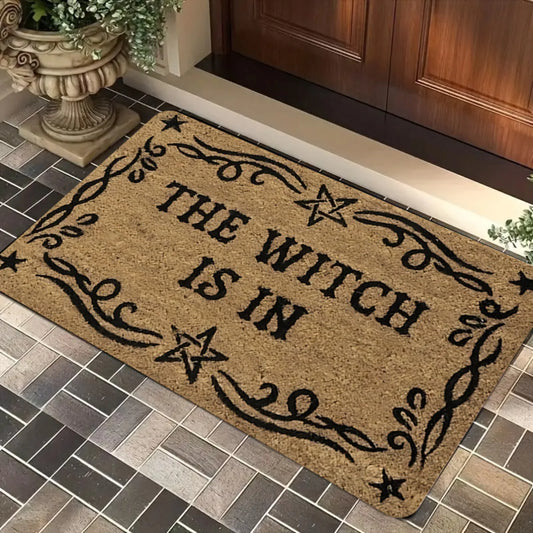 A Magical Doormat Featuring 'THE WITCH IS IN', Made of Plush Material with a Thickness of 0.4 Inches And Weighing 1.28 LB. It Has a Brown Base with a Black Star And Spell Design, for Halloween